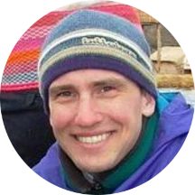 headshot of Adam, smiling